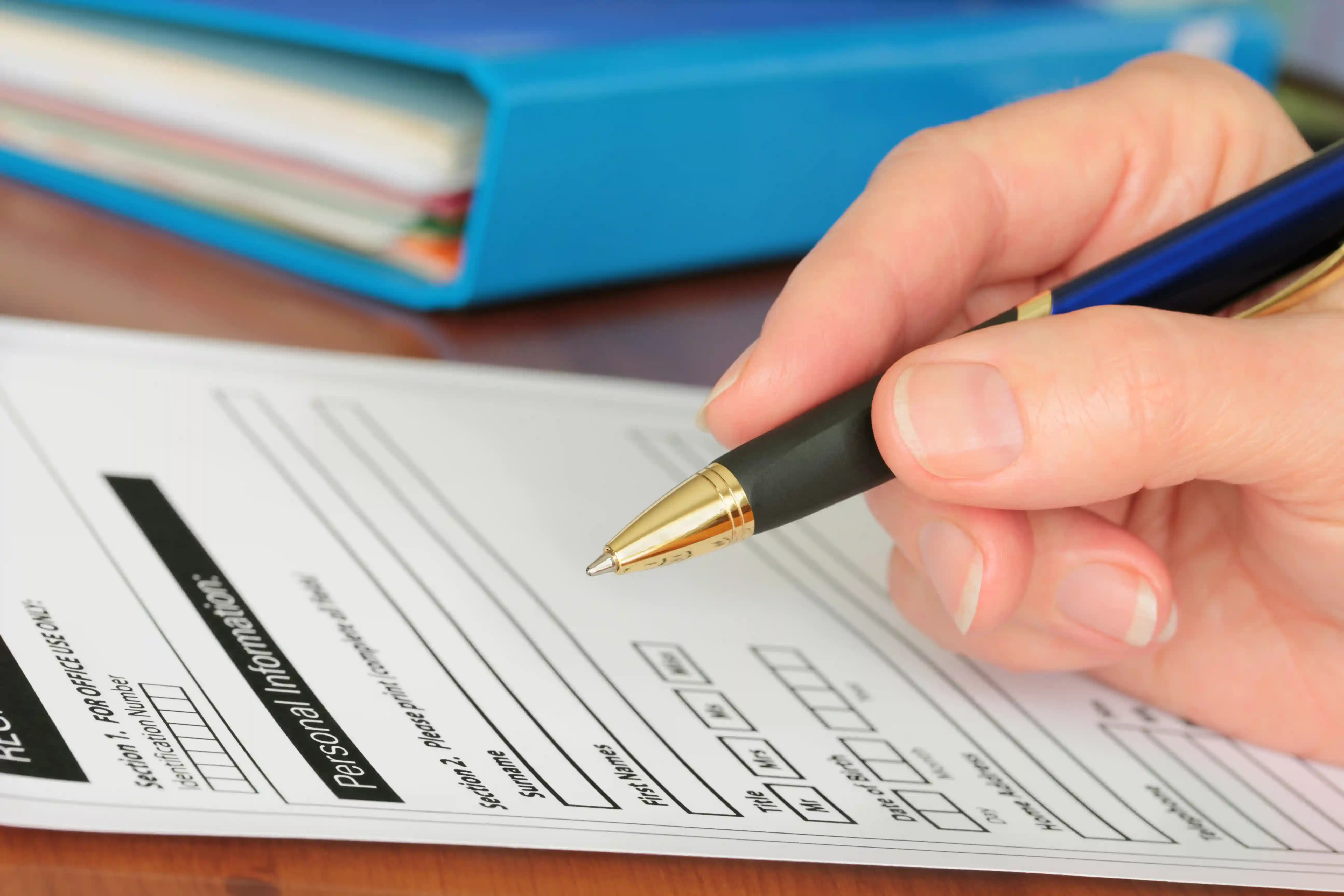 closeup of someone filling out an insurance form