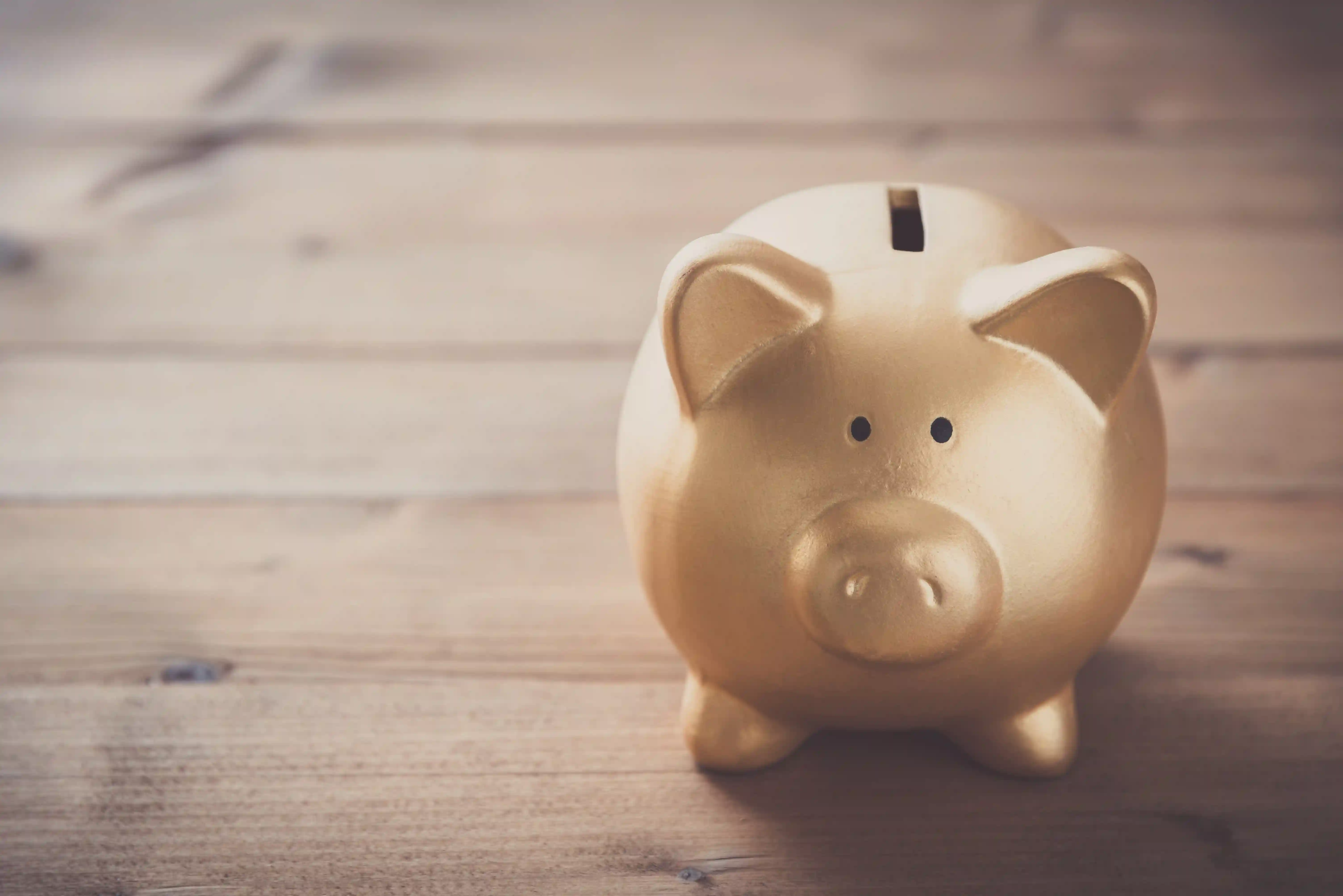 Piggy bank on wood table background